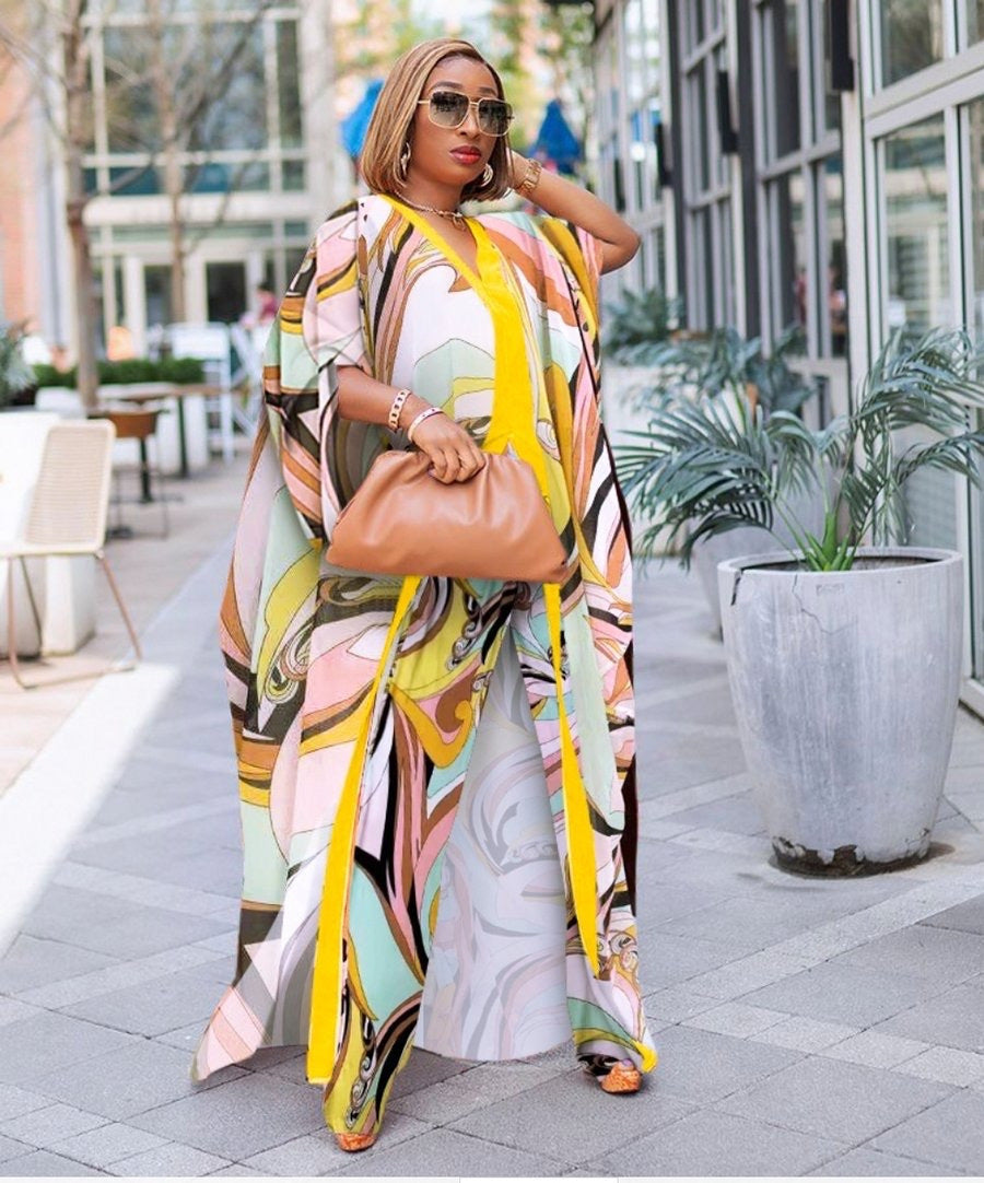 Woman in a colorful outfit walking outdoors on a city street.