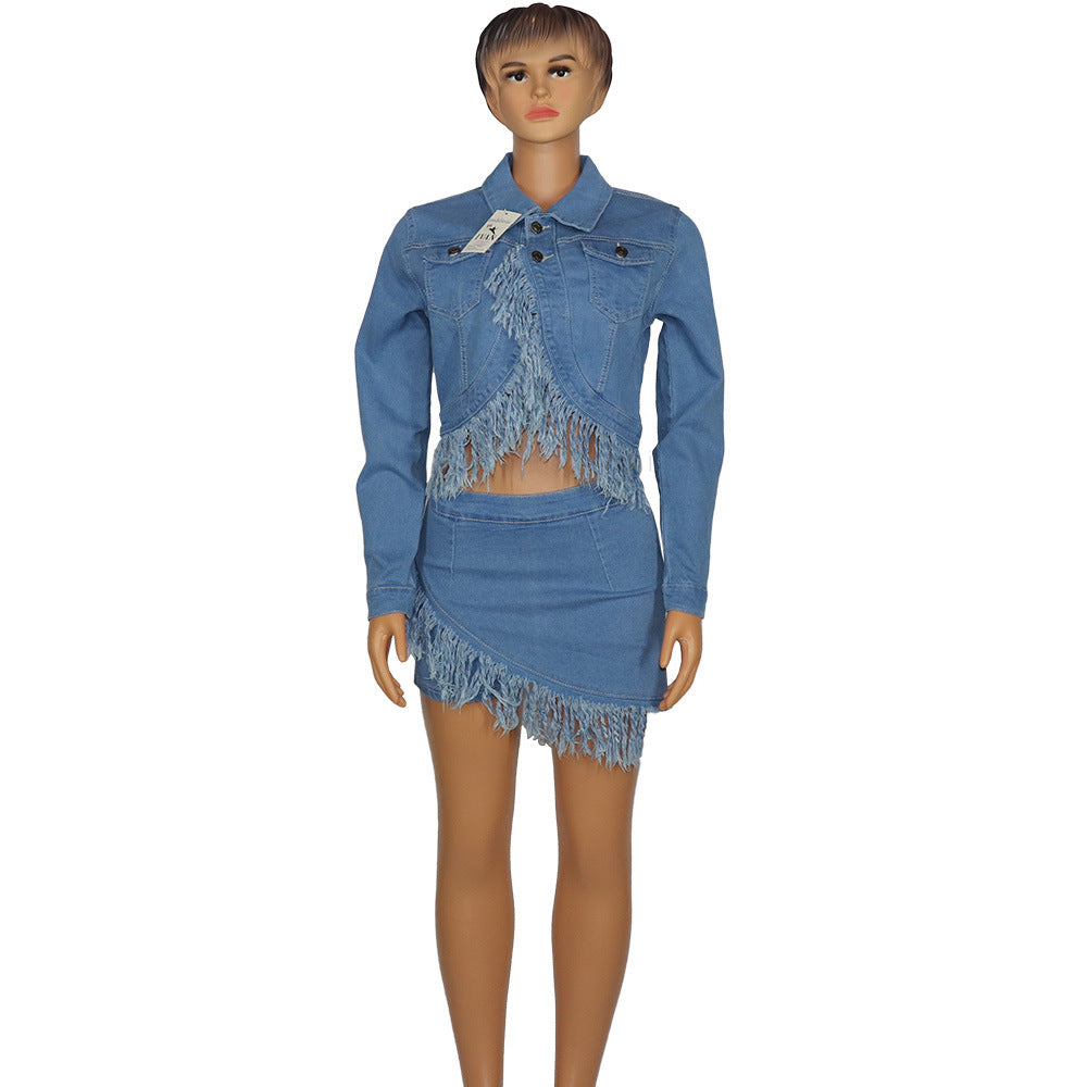Mannequin wearing a blue denim outfit with fringe details on a white background