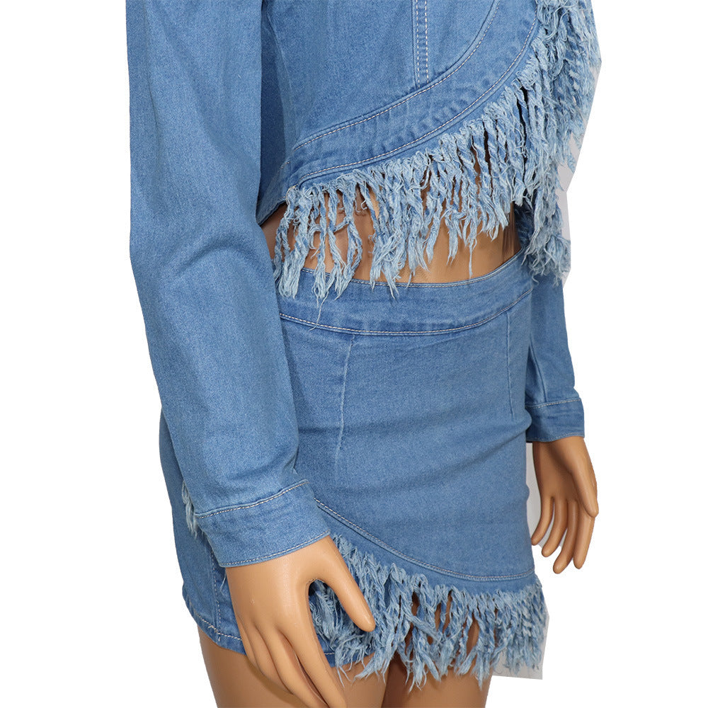 Blue denim jacket and skirt set with fringe details on a mannequin against a white background