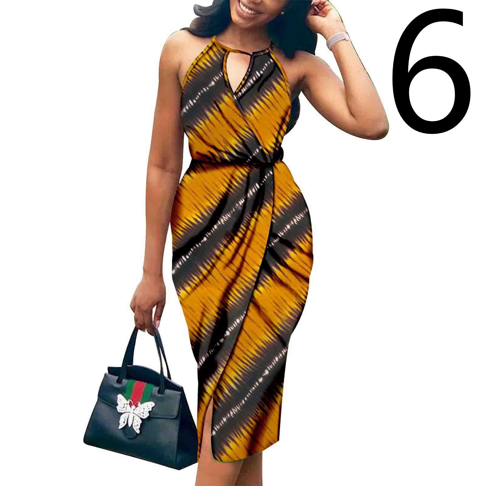 Woman wearing a yellow and black patterned dress holding a black handbag with a visible brand logo on a white background.