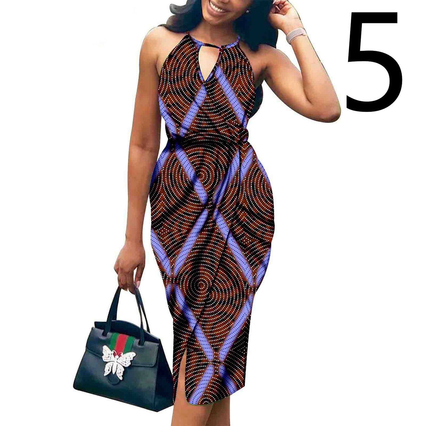 Woman wearing a patterned dress holding a handbag on a white background