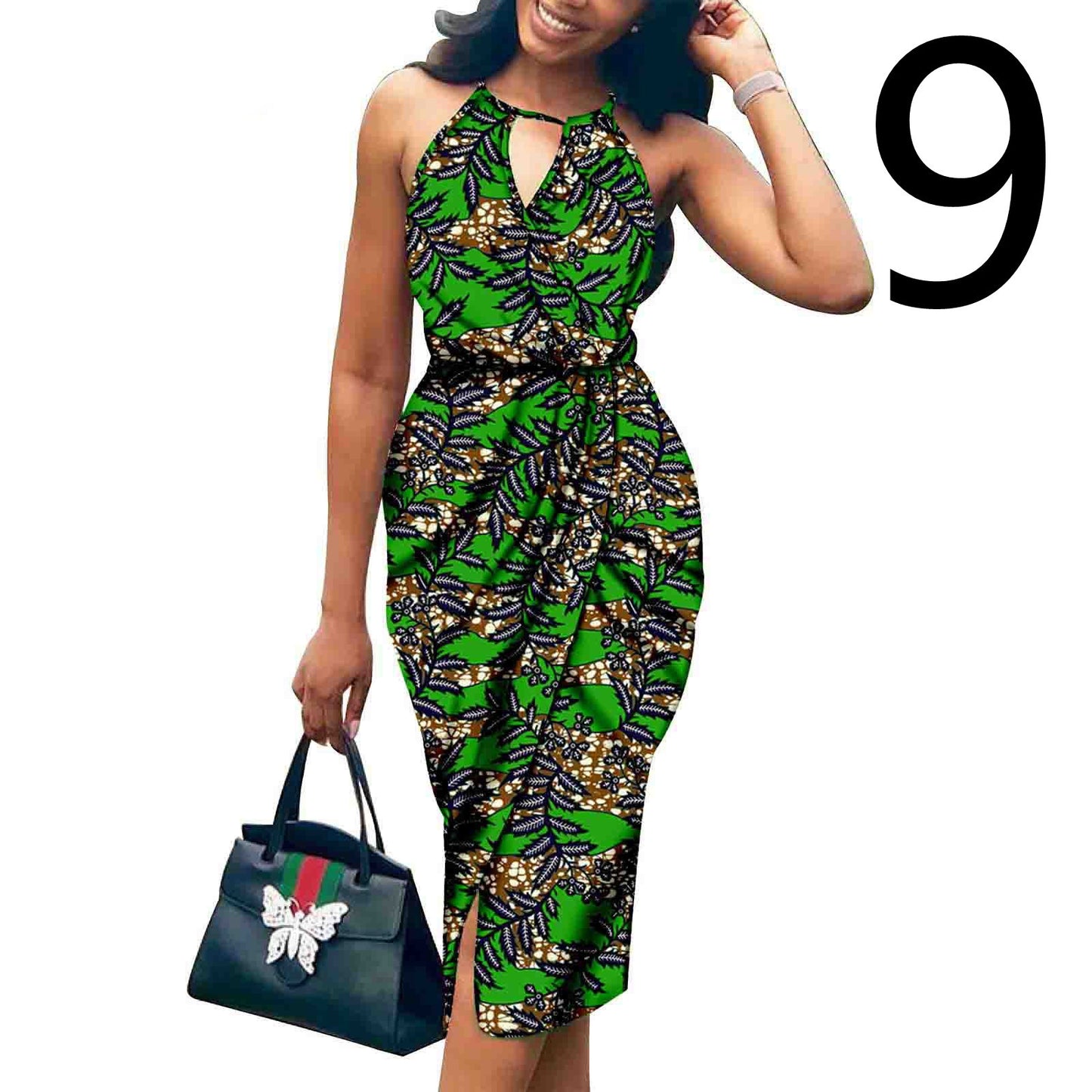 Woman wearing a green and black patterned dress holding a Gucci handbag on a white background.