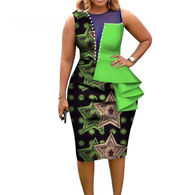Woman wearing a green and black patterned dress with star designs on a white background