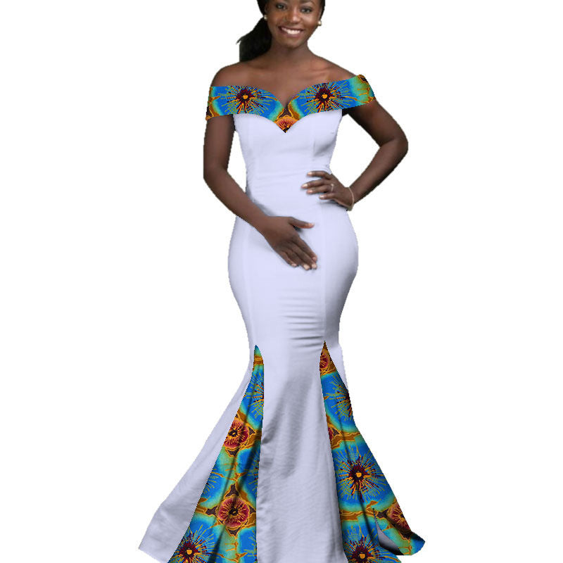 Woman wearing a white dress with colorful floral patterns on a white background