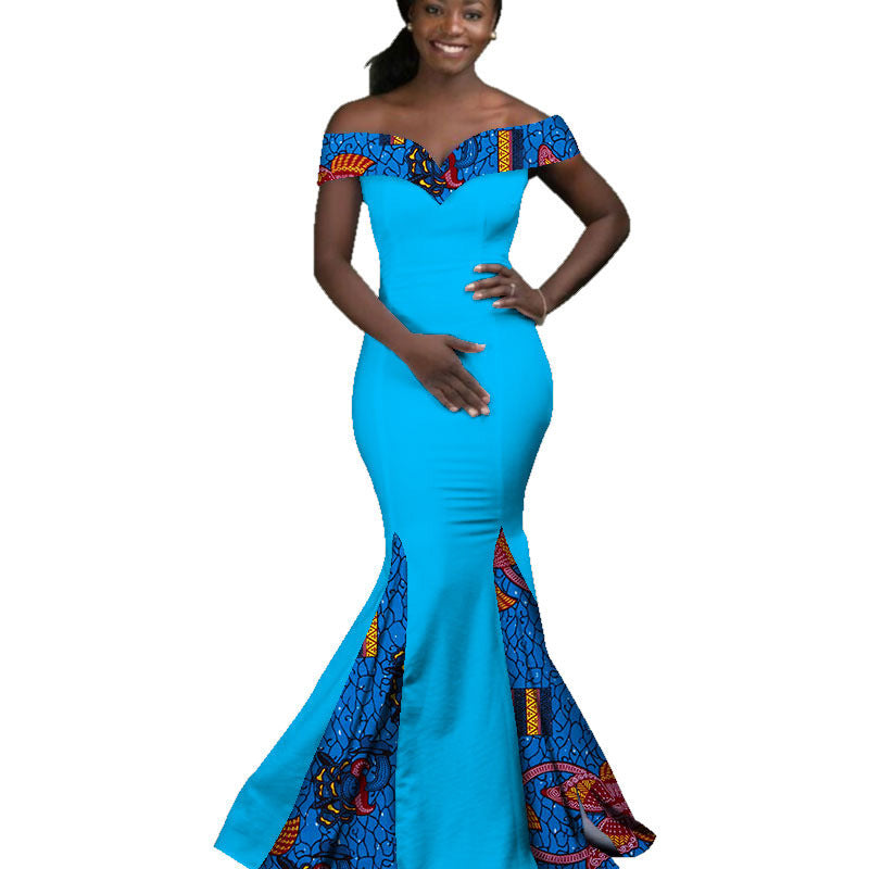 Woman wearing a blue off-shoulder dress with colorful patterns on a white background