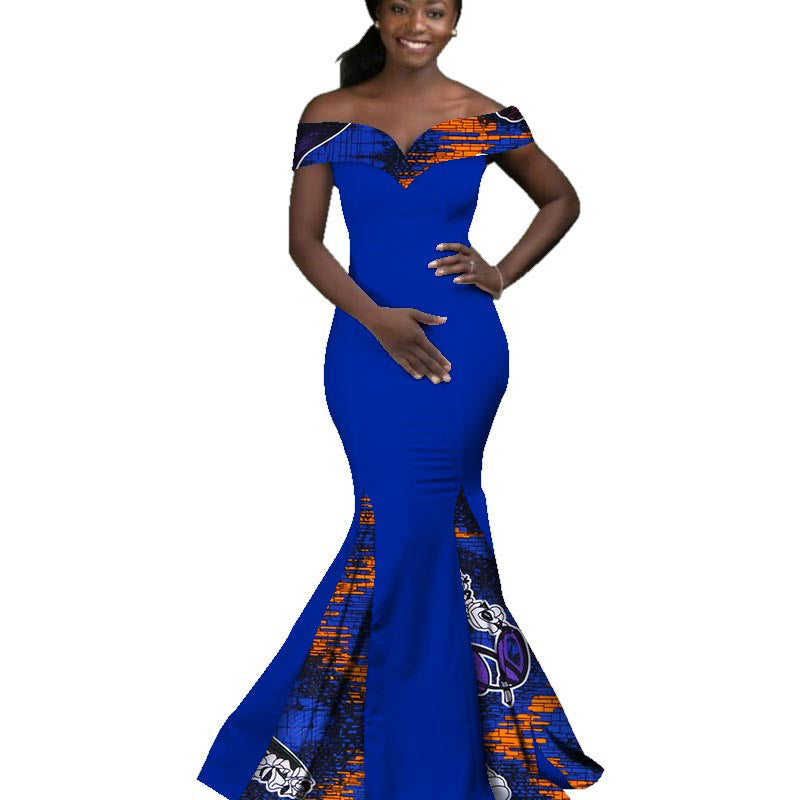 Woman wearing a blue and orange patterned dress on a white background