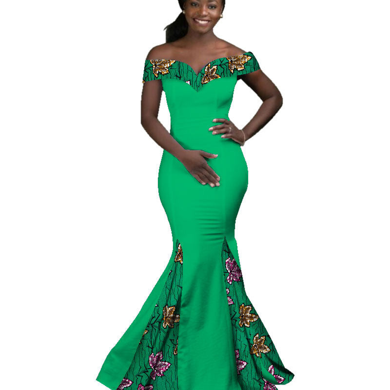 Green evening gown with floral patterns on a white background
