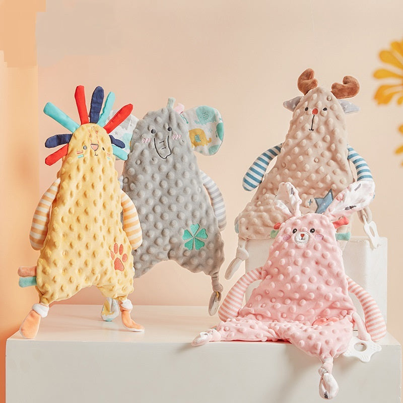 Four colorful plush toys on a white platform with a light pink background