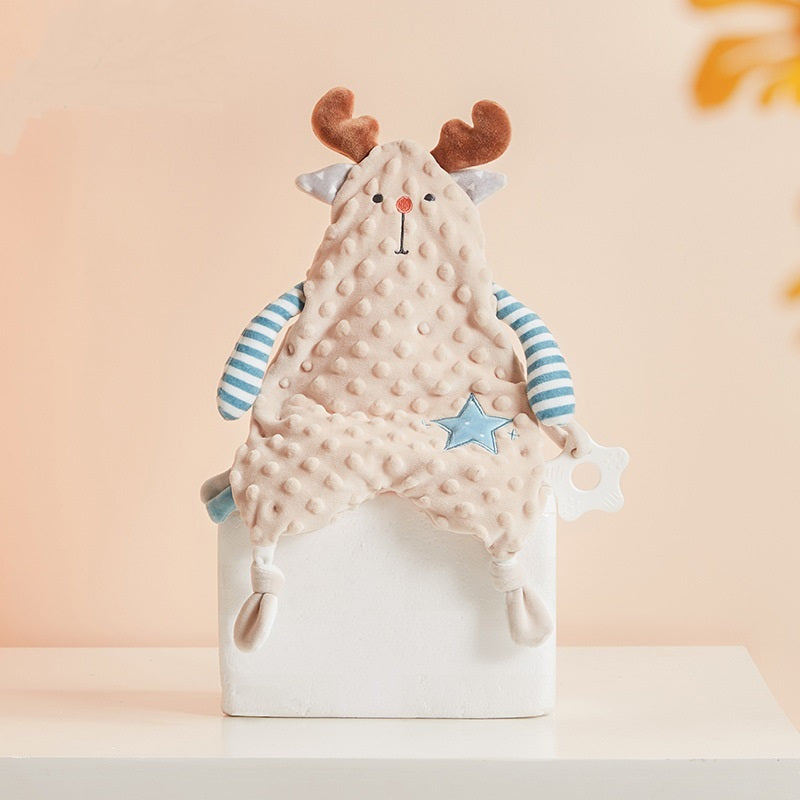 Baby comfort blanket with deer design on a white stand against a light pink background