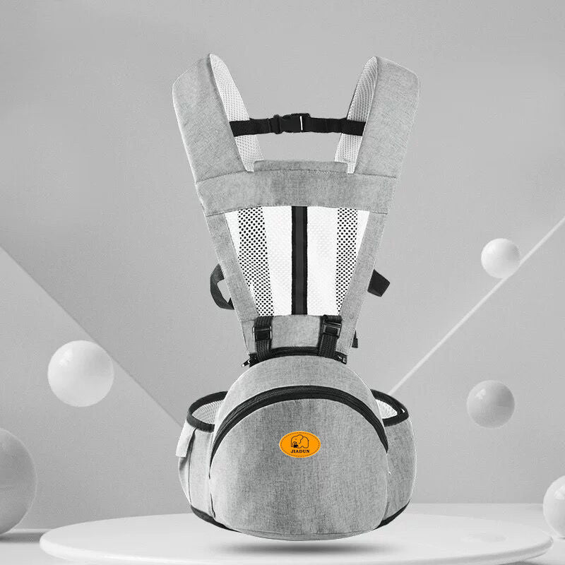 Gray baby carrier with black straps on a gray background