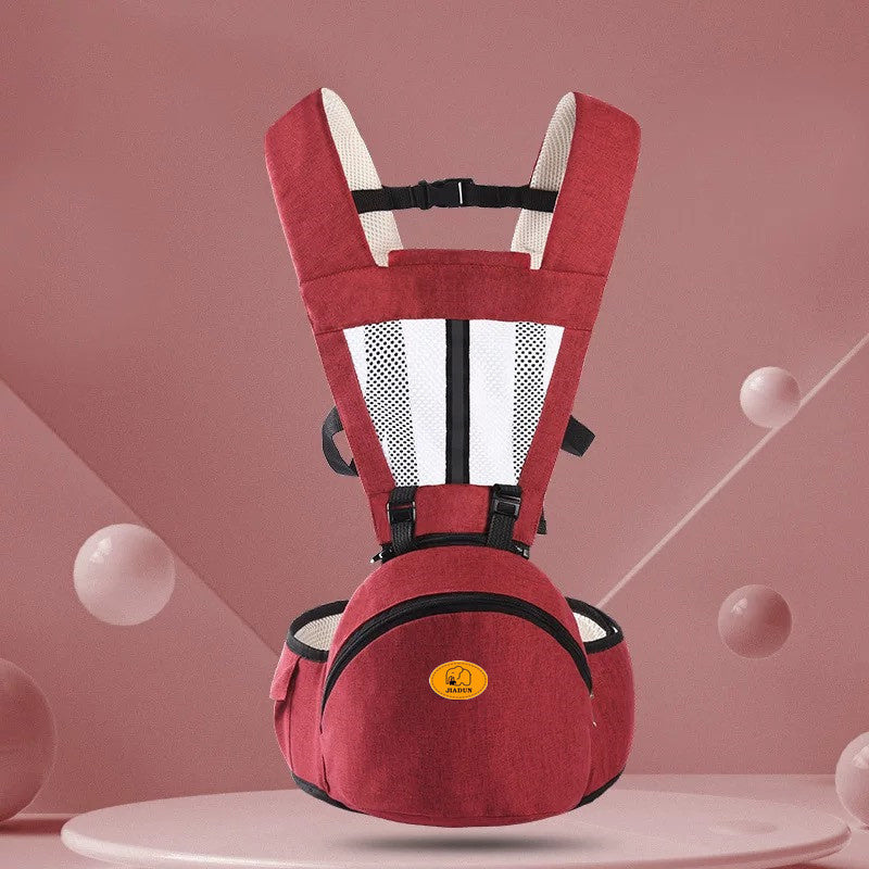 Red baby carrier on a pink background