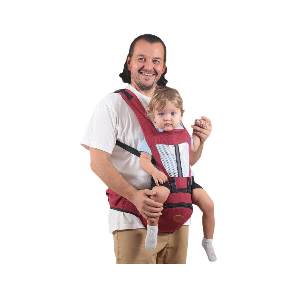 Man holding a child in a red baby carrier against a white background