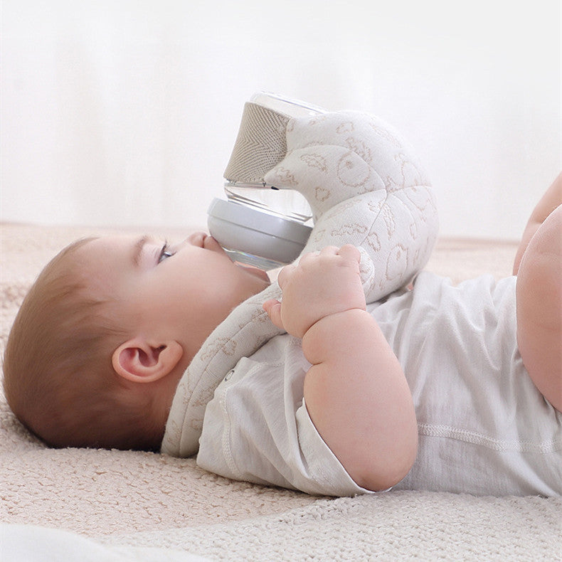Baby lying on a soft surface playing with a textured toy