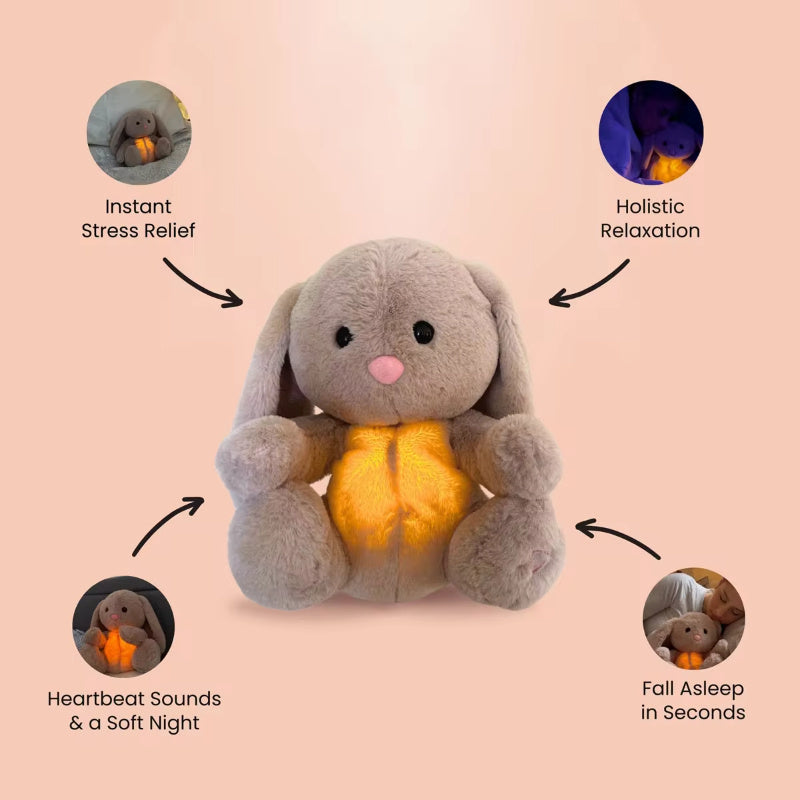 Plush bunny with glowing belly on a pink background, labeled for stress relief, relaxation, heartbeat sounds, and sleep aid.