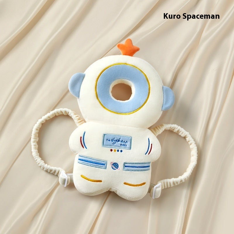 Plush toy resembling a spaceman with a star on its head, branded 'Kuro Spaceman', against a beige curtain background.