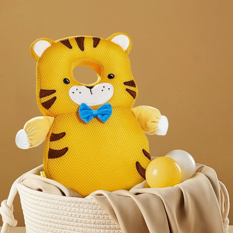 Yellow tiger plush toy with a blue bow tie in a basket on a brown background