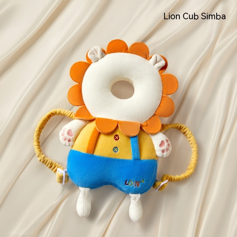 Plush toy lion cub with orange mane and blue overalls on a beige background