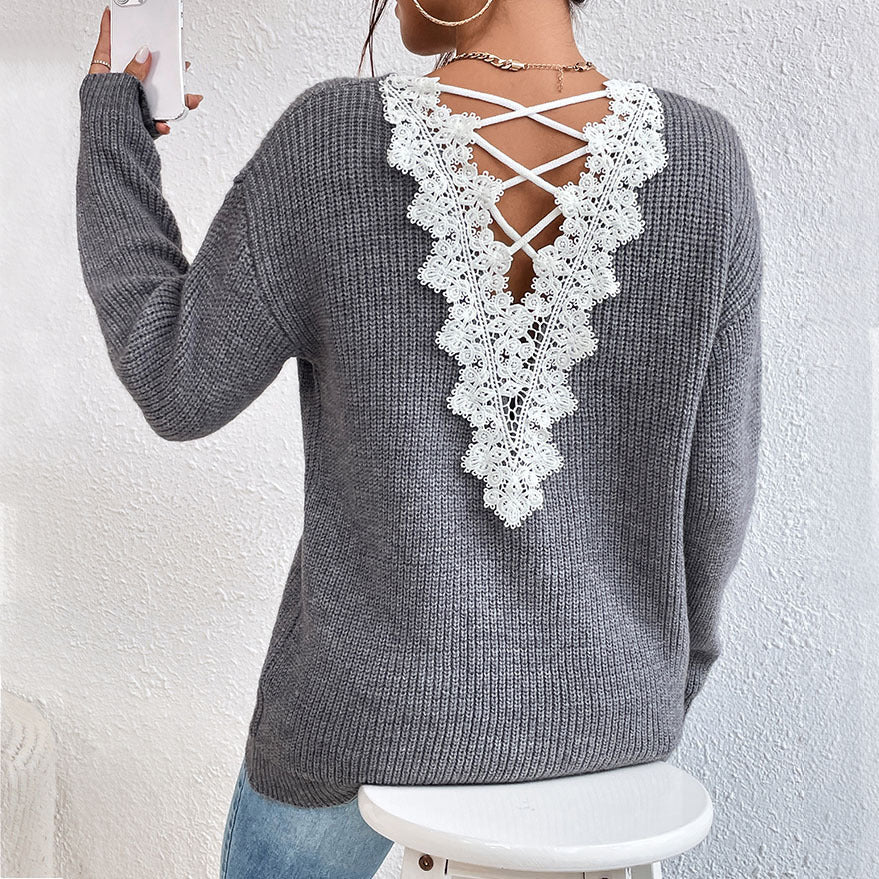 Gray sweater with white lace back design worn by a person, against a white background