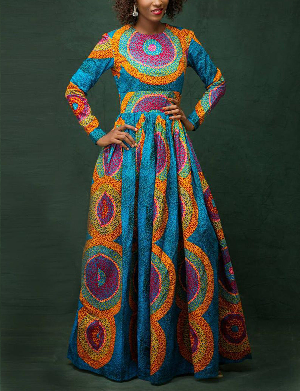 Woman wearing a colorful, patterned dress against a dark background