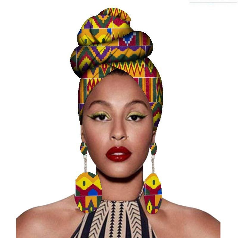 Woman wearing a colorful headwrap and earrings on a white background