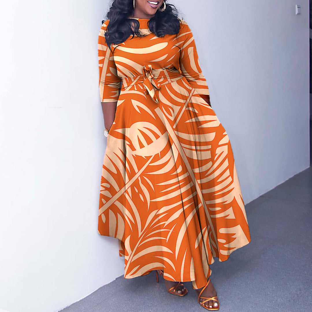 Woman wearing an orange and white patterned dress against a plain background