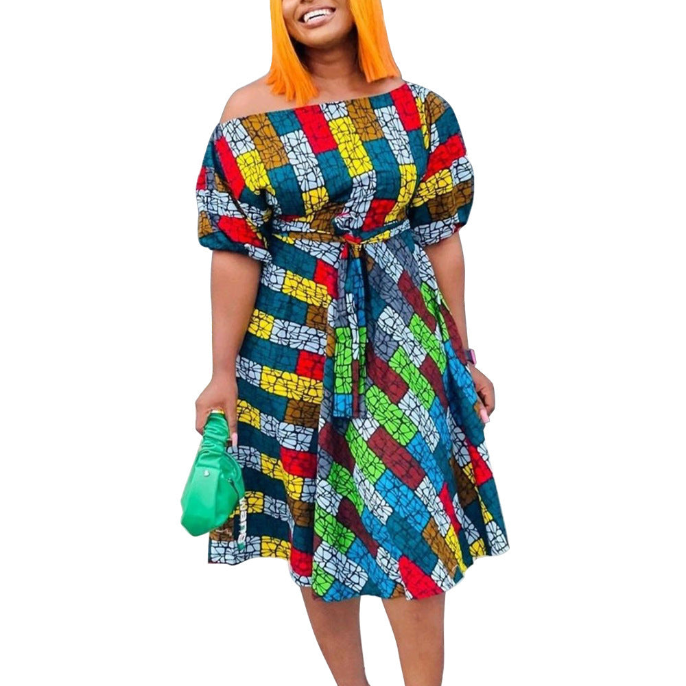 Woman wearing a colorful patterned dress on a white background