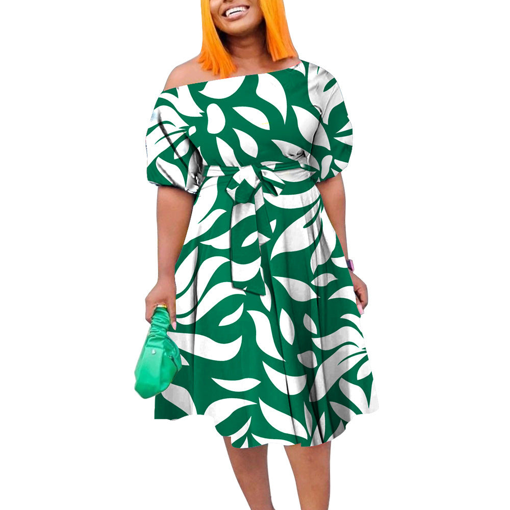 Woman wearing a green and white patterned dress on a white background