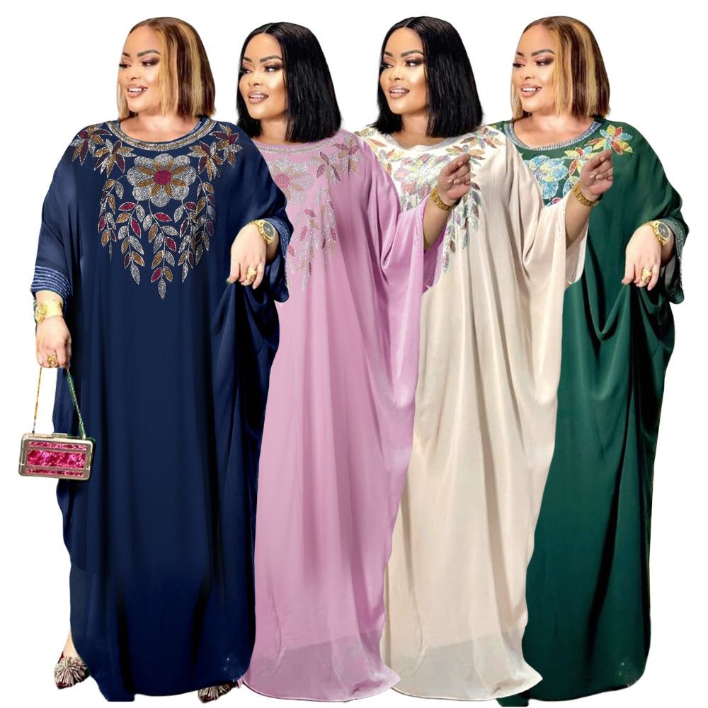 Four women wearing long, embroidered dresses in blue, pink, white, and green on a white background.