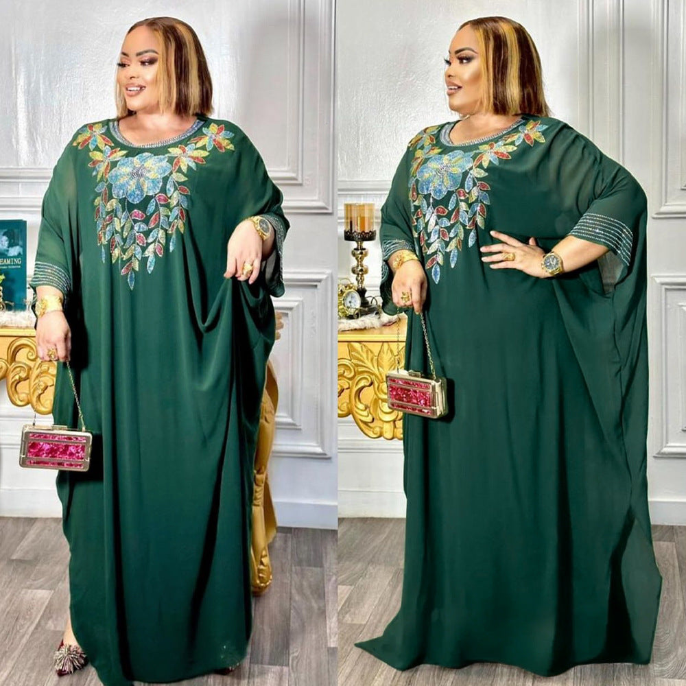 Woman wearing a green dress with floral embroidery in two different poses.