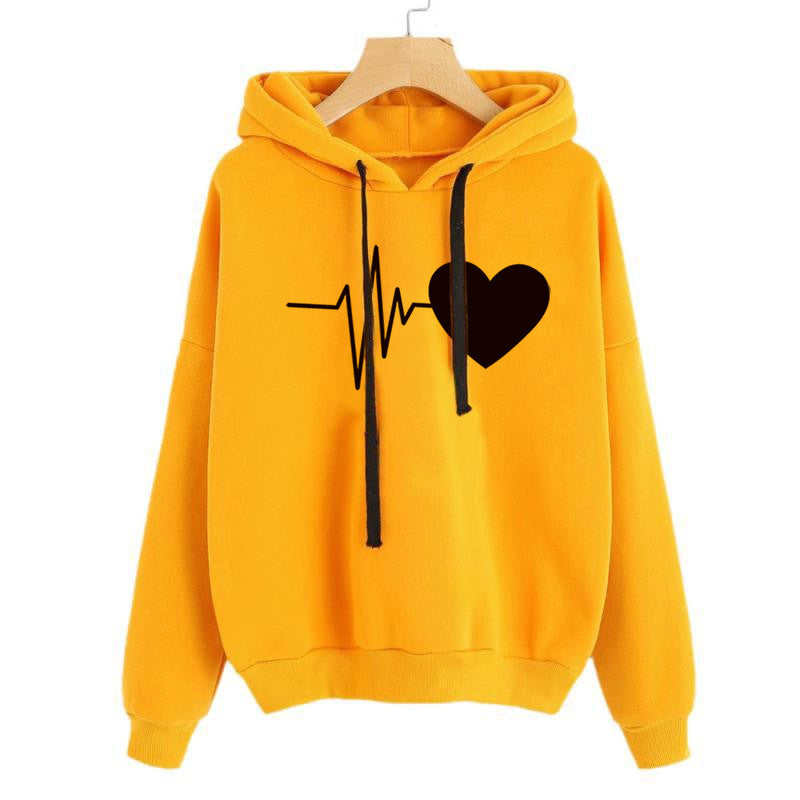 Yellow hoodie with a black heart and line design on a white background