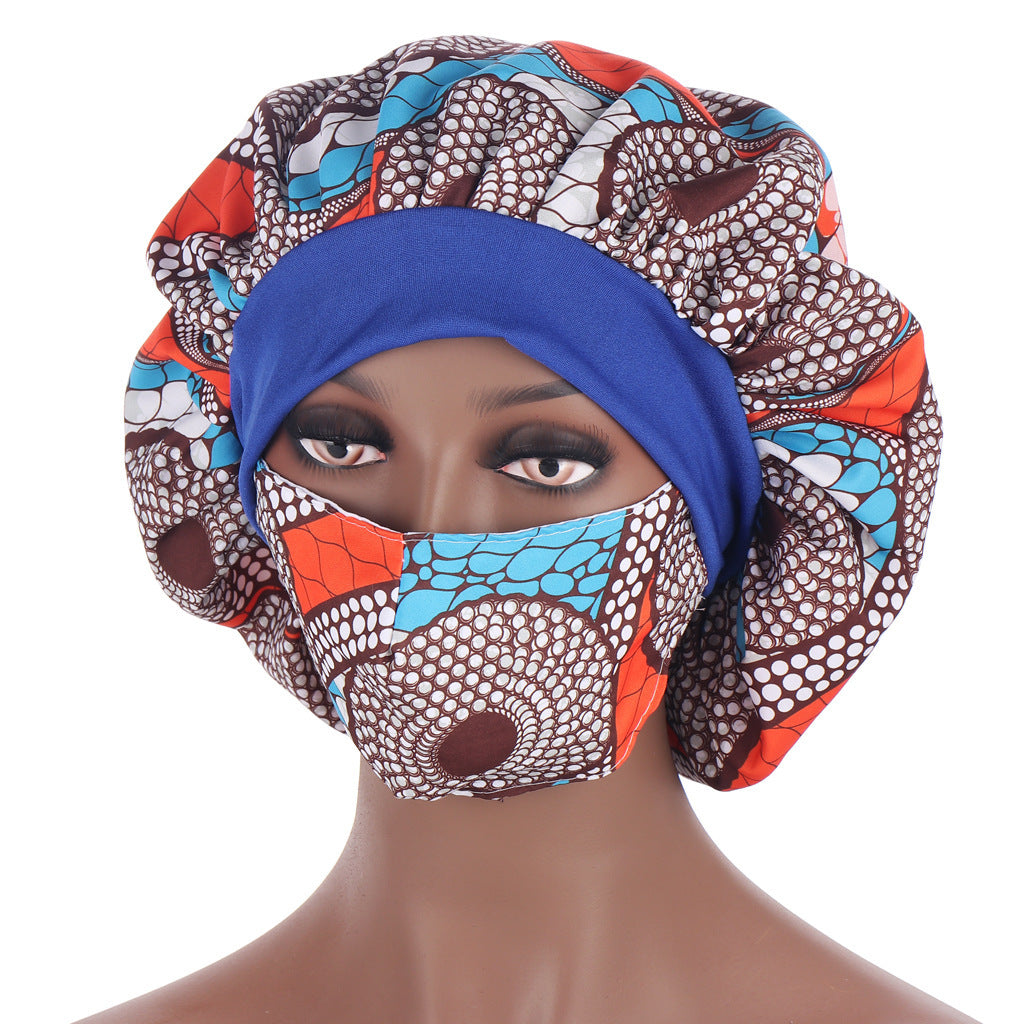 Mannequin head wearing a colorful headscarf and face mask with a white background