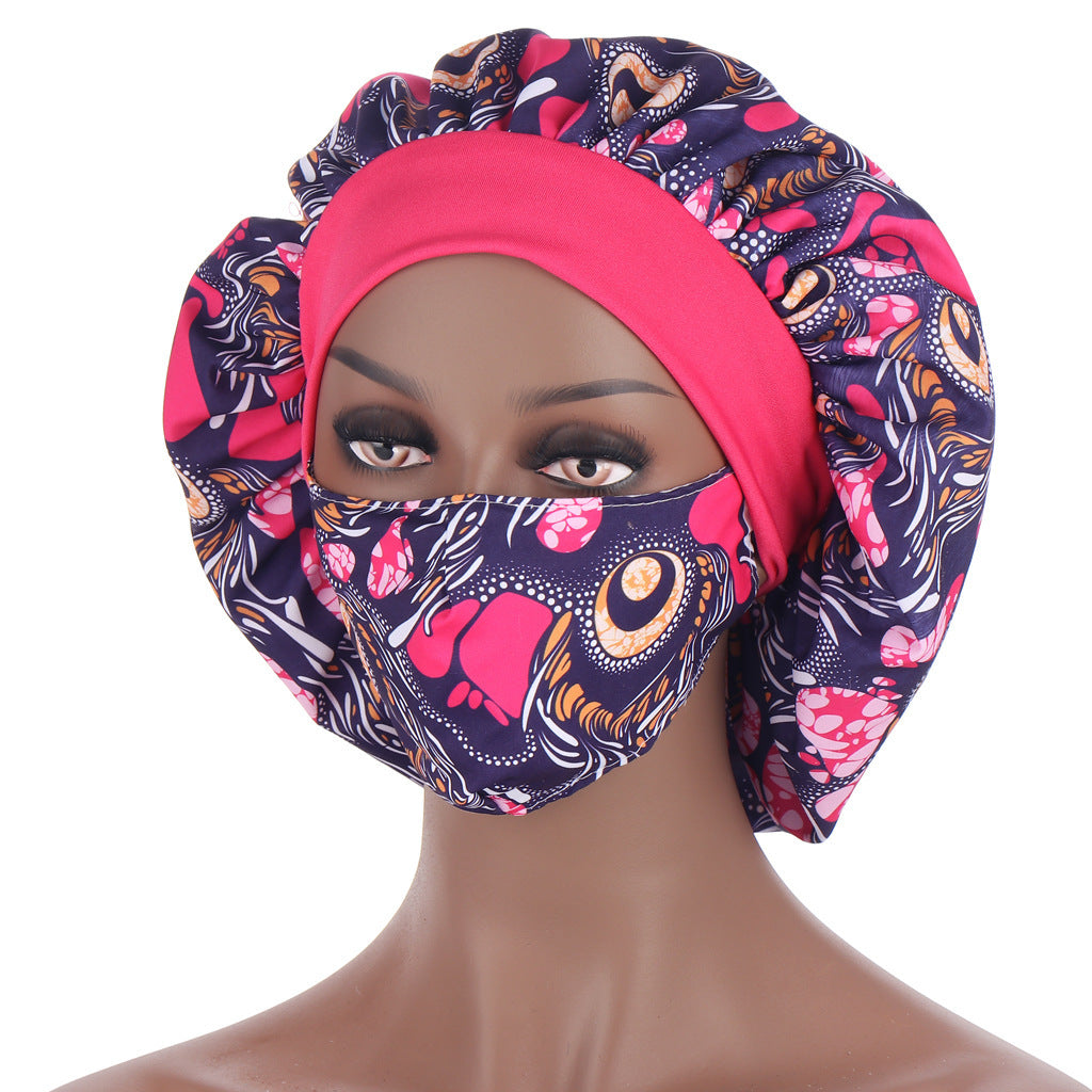 Colorful headscarf with floral pattern on a mannequin head against a white background