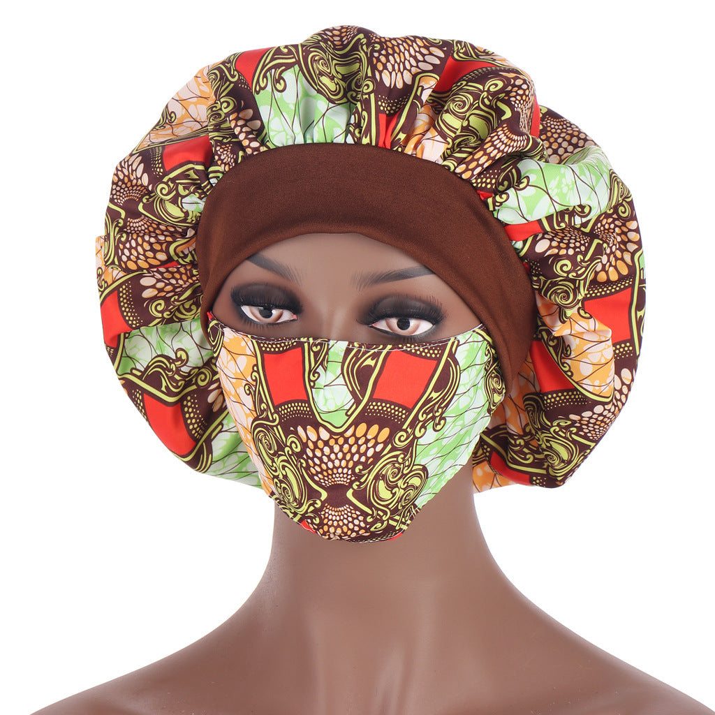 Mannequin head wearing a colorful patterned headscarf and face mask on a white background