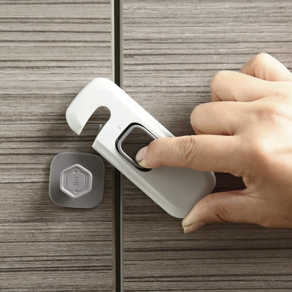 Hand using a white bottle opener on a wooden surface