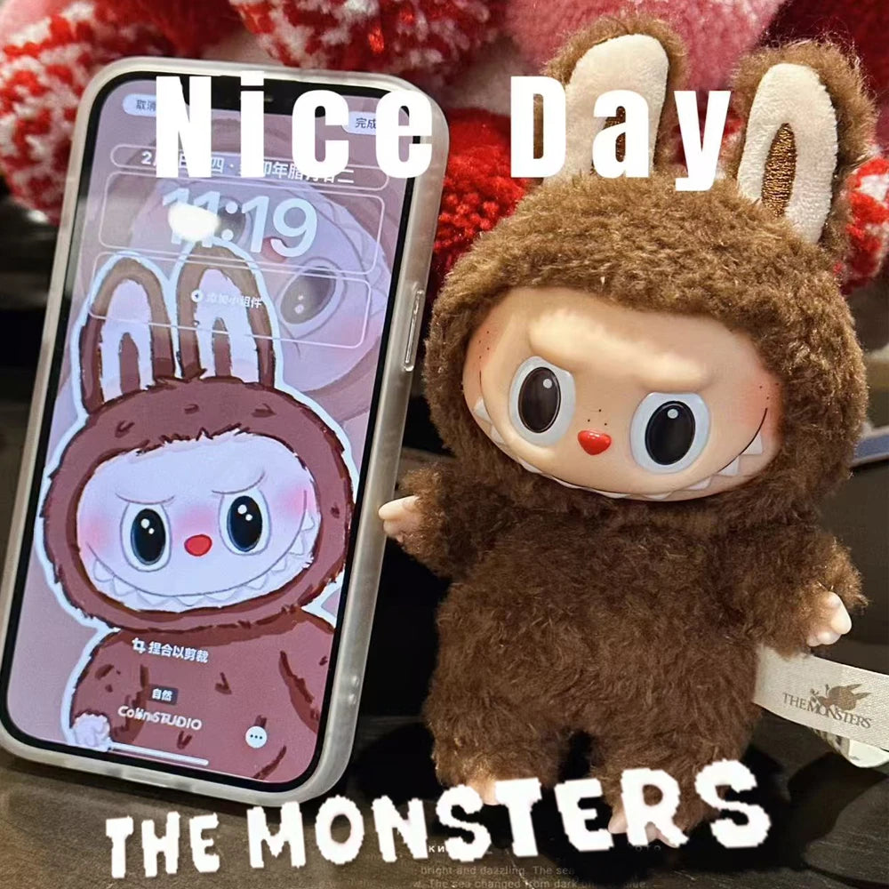 Plush toy and phone with 'The Monsters' app on screen, text 'Nice Day' above.