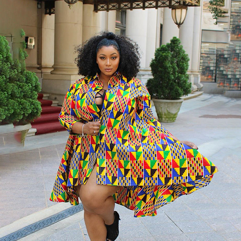 Woman wearing a colorful patterned dress standing outdoors.
