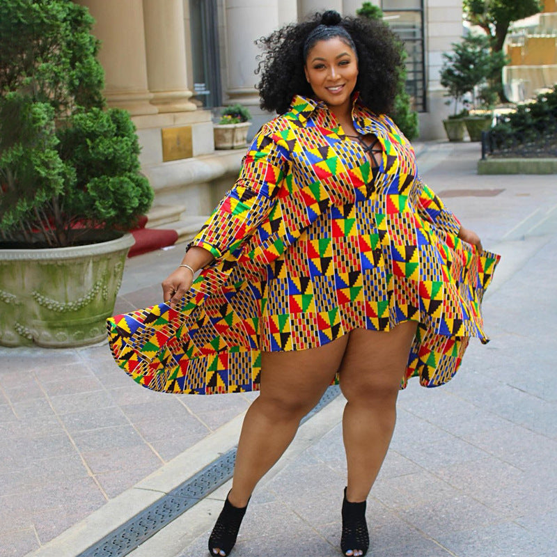 Woman wearing a colorful patterned dress standing outdoors.