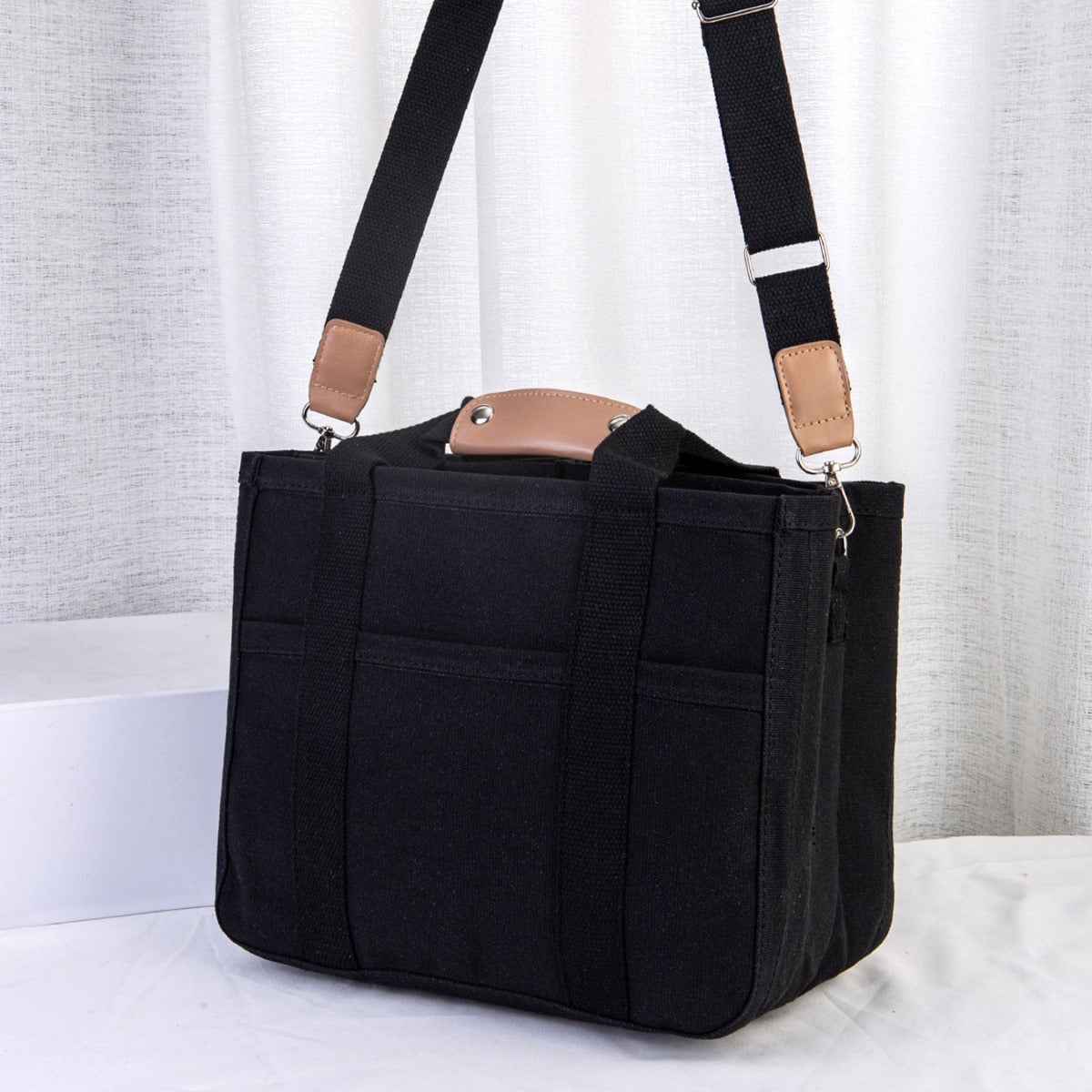 Black bag with a strap on a white background