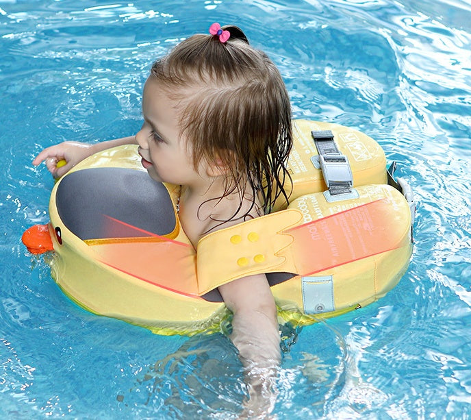 Child wearing a yellow inflatable swim ring with a duck design in blue water.