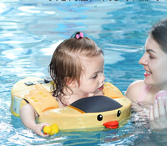Child in a yellow inflatable duck float with a woman in a pool