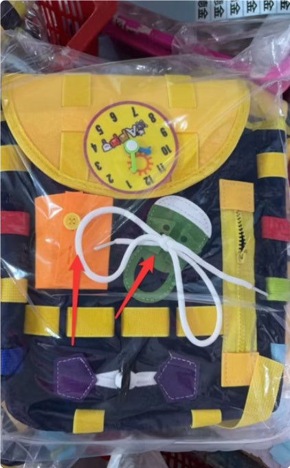 Colorful toy life jacket with various buttons and a rope, partially wrapped in plastic.