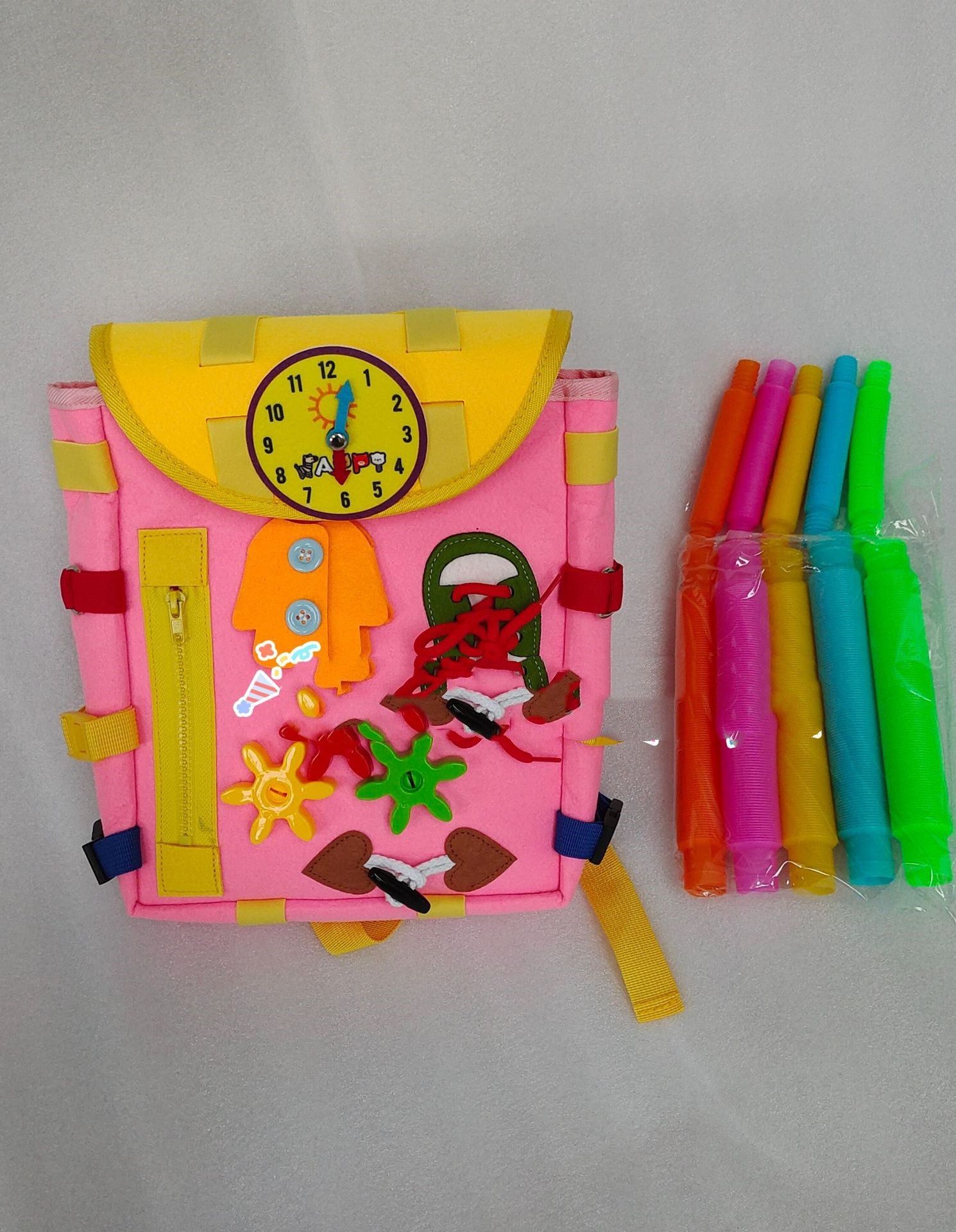 Colorful children's activity book with stickers and a set of straws on a gray background