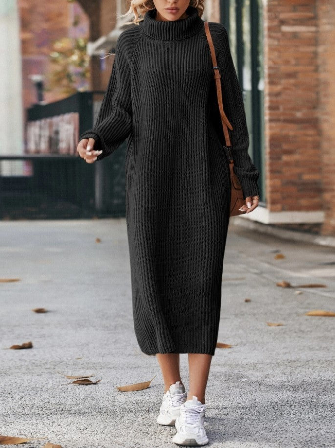 Person wearing a black ribbed knit dress with white sneakers on a street.