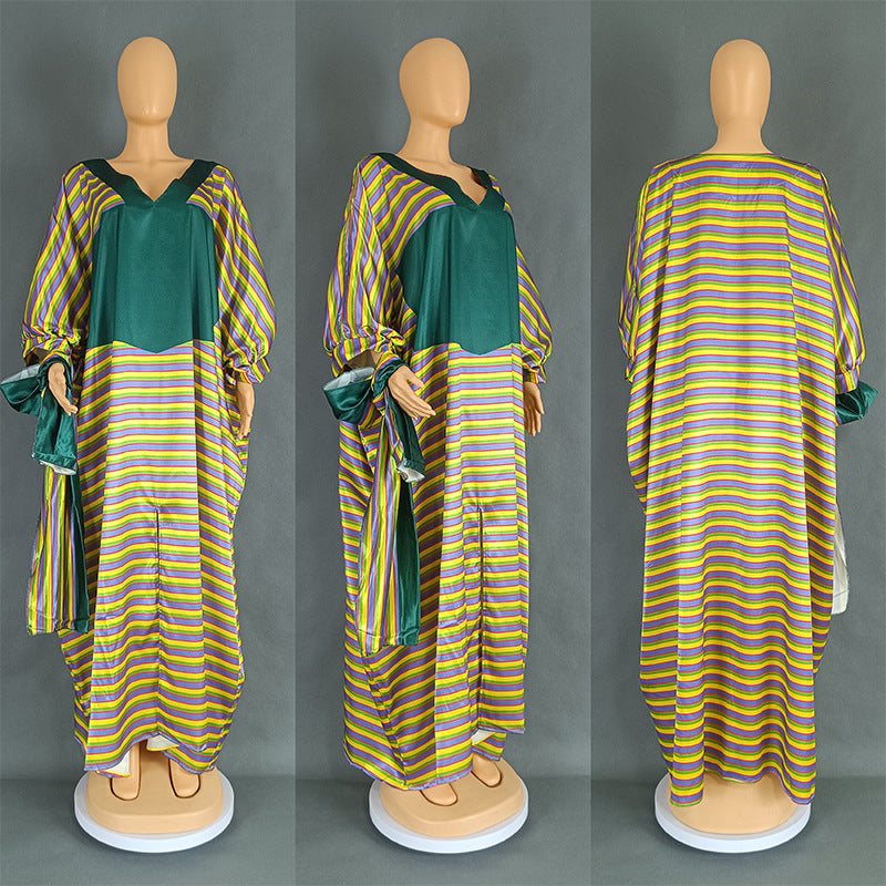 Mannequin wearing a green and yellow striped dress on a gray background