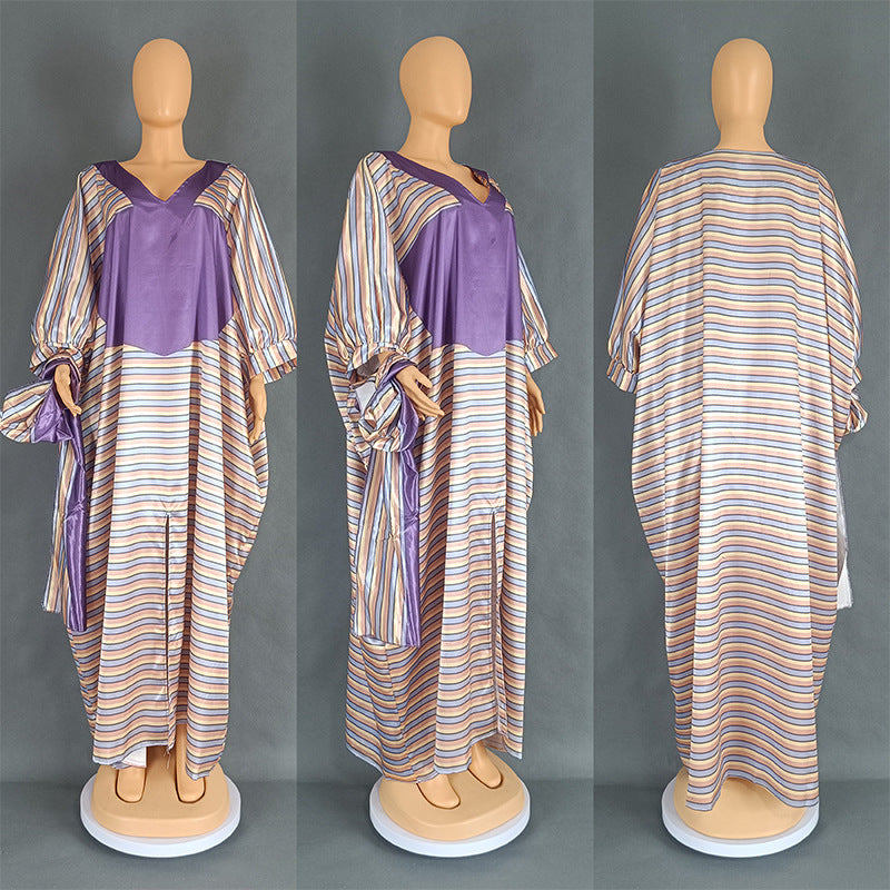 Striped dress with purple accents on a mannequin against a gray background