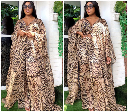 Woman wearing a zebra print dress in two different poses against a white wall with greenery.