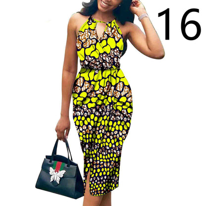 Woman wearing a colorful patterned dress holding a Gucci handbag on a white background