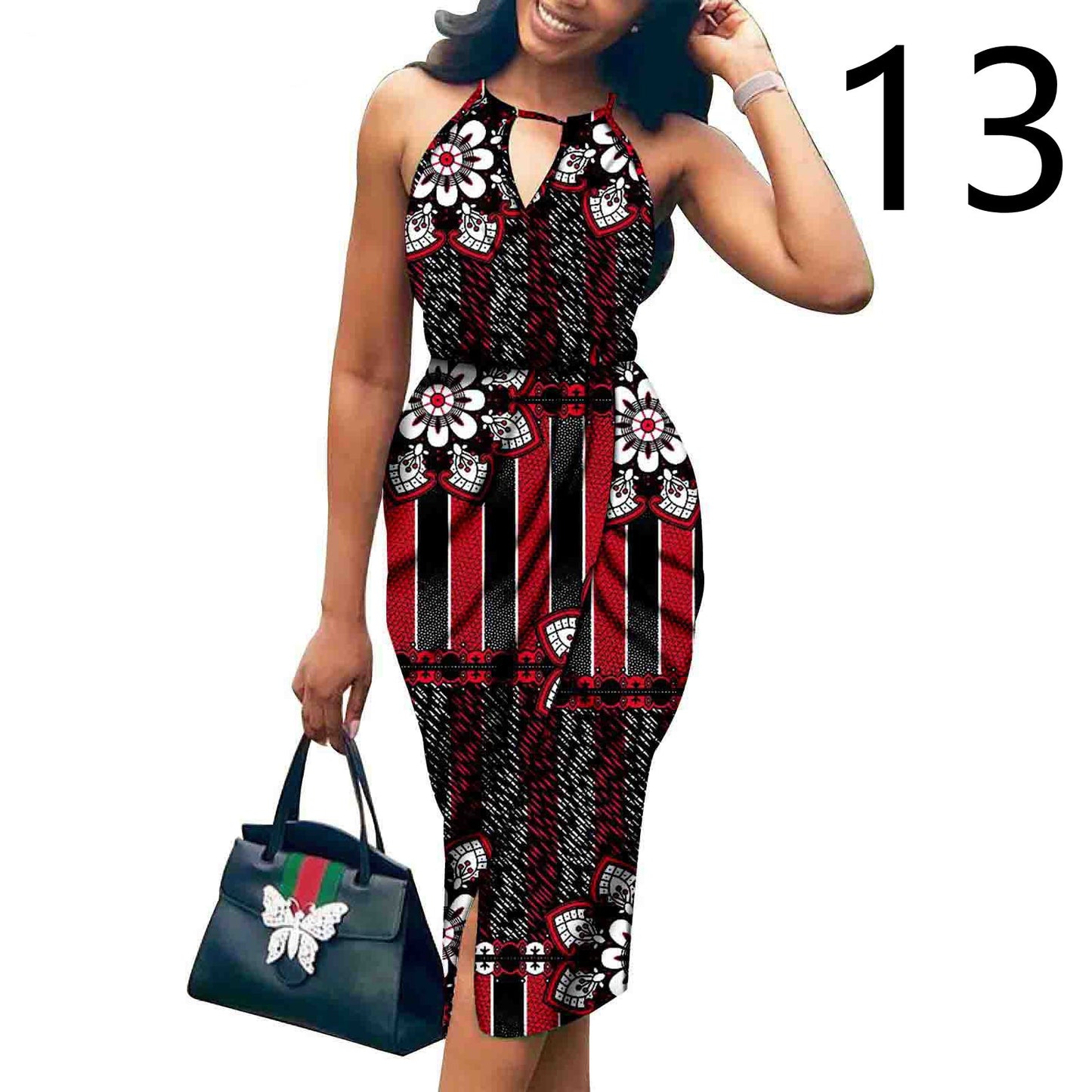 Woman wearing a red and black patterned dress holding a green handbag on a white background.