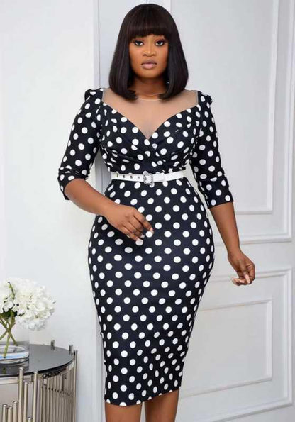 Woman wearing a black and white polka dot dress against a white background