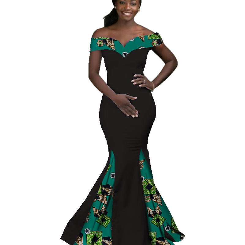 Woman wearing a black and green patterned dress on a white background
